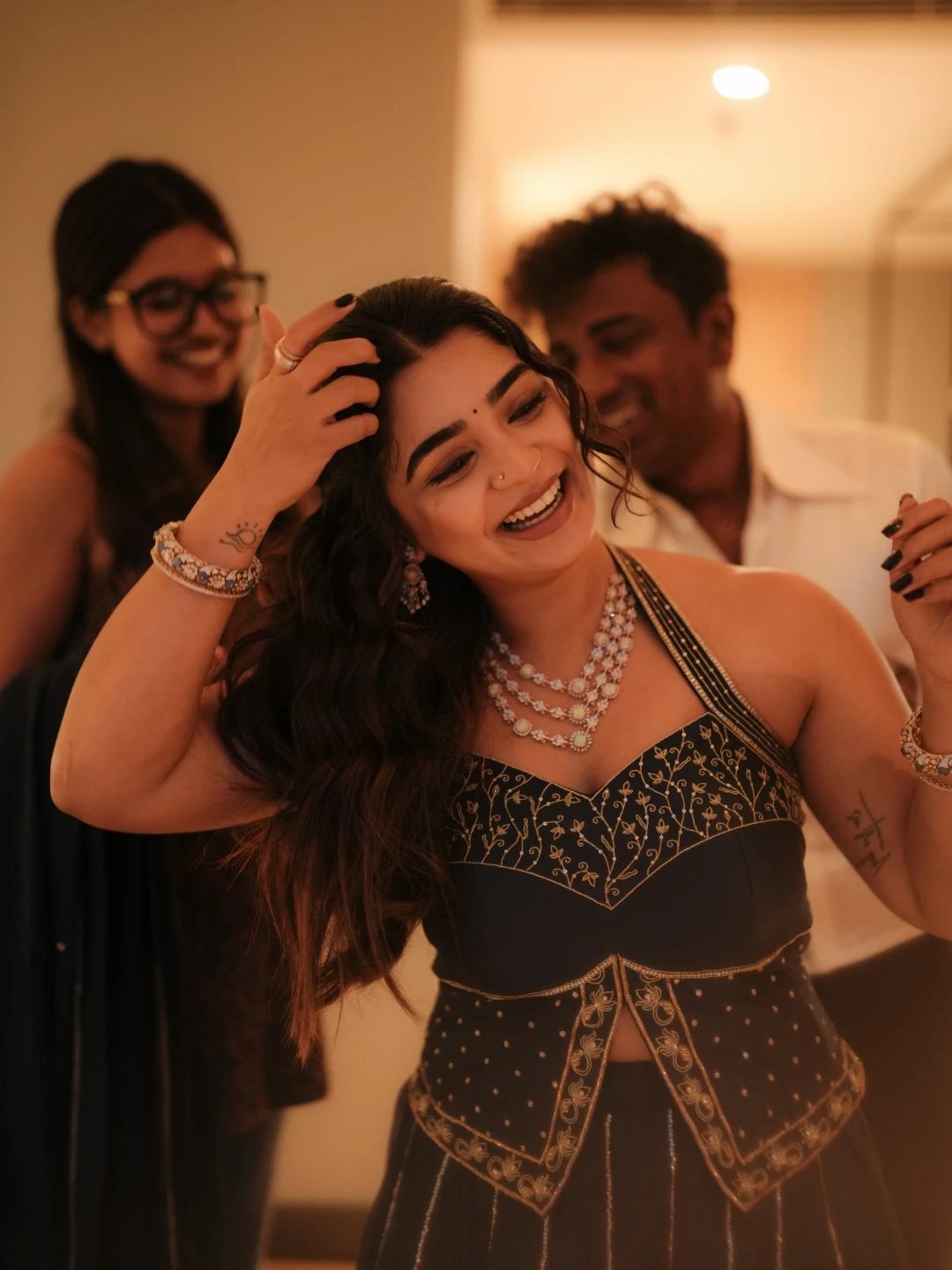 Actress Gouri Kishan laughing candidly with styling crew on ad film set
