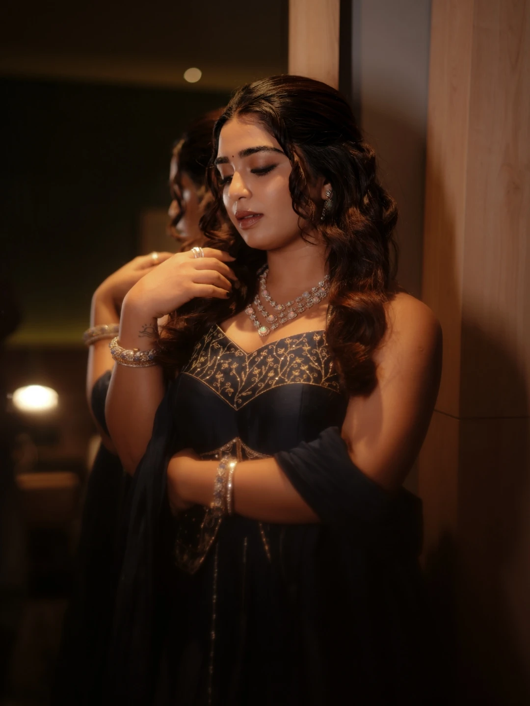 Gouri Kishan side profile portrait posing near mirror in festive navy outfit